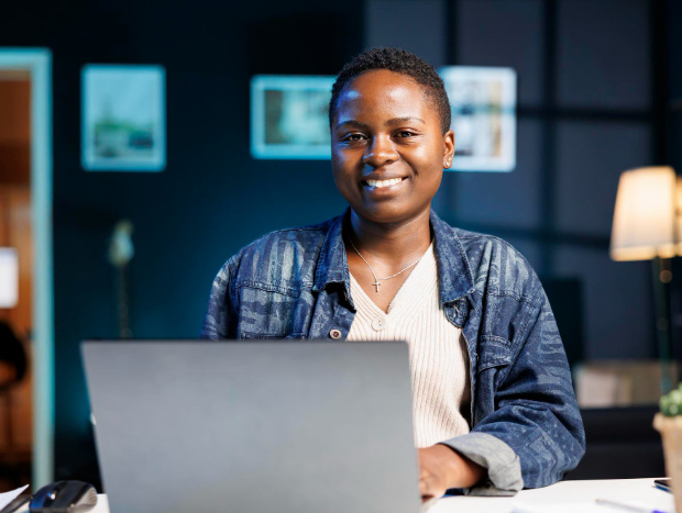 young lady siting behind a laptop